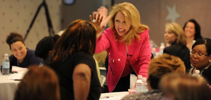 Monica Wofford, CSP gives a high five to a Contagious Conference&trade; participant.